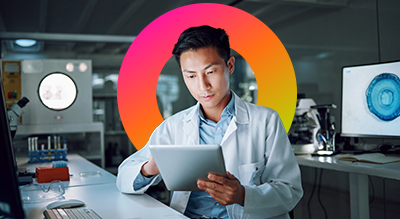 Healthcare employee using a tablet device in a lab setting